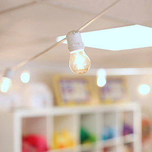 Light strand inside a room with colorful cubbies in the background